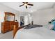 Bedroom featuring wood furnishings, a ceiling fan, and a view into the hall and living room at 2396 Caraway Dr, Venice, FL 34292
