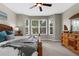 Comfortable bedroom featuring a bay window, ceiling fan, and traditional wood furnishings at 2396 Caraway Dr, Venice, FL 34292
