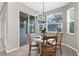 Bright dining area with a view through sliding glass doors to a screened-in patio and backyard at 2396 Caraway Dr, Venice, FL 34292