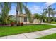 Beautifully landscaped front yard showcasing the home's charming facade and curb appeal at 2396 Caraway Dr, Venice, FL 34292