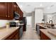 Modern kitchen featuring dark wood cabinets, stainless steel appliances, and ample counter space at 2396 Caraway Dr, Venice, FL 34292