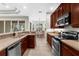 Modern kitchen featuring sleek appliances, ample counter space, and seamless flow to dining at 2396 Caraway Dr, Venice, FL 34292