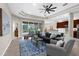 Bright open living area with tray ceiling, neutral tones, stylish furnishings and tile flooring at 2396 Caraway Dr, Venice, FL 34292
