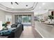 Open living room featuring access to outdoor area, breakfast bar and modern lighting at 2396 Caraway Dr, Venice, FL 34292