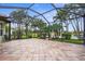 A covered lanai offers great lake views, tile floor, and a screen enclosure at 2396 Caraway Dr, Venice, FL 34292