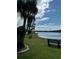 Relaxing lakefront view with a bench at 3310 Loveland Blvd # 1406, Punta Gorda, FL 33980