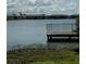 Serene lake view with a wooden dock at 3310 Loveland Blvd # 1406, Punta Gorda, FL 33980