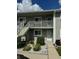 Two-story condo building with updated exterior and landscaping at 3310 Loveland Blvd # 1406, Punta Gorda, FL 33980