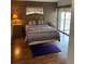 Bedroom with double bed, dresser, and access to balcony at 3310 Loveland Blvd # 1406, Punta Gorda, FL 33980
