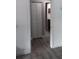 Bright hallway with gray vinyl flooring and a view of a bathroom at 18245 Ackerman Ave, Port Charlotte, FL 33948