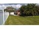 Large backyard with a white fence at 18245 Ackerman Ave, Port Charlotte, FL 33948