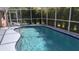 Inviting screened-in pool area, ready for relaxation at 18245 Ackerman Ave, Port Charlotte, FL 33948