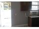 Kitchen with door to backyard and dark wood cabinets at 18245 Ackerman Ave, Port Charlotte, FL 33948