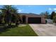 Single-story house with a two-car garage and yard at 18245 Ackerman Ave, Port Charlotte, FL 33948