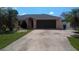 Single-story house with a two-car garage and yard at 18245 Ackerman Ave, Port Charlotte, FL 33948