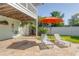 Relaxing backyard featuring lounge chairs, a sun umbrella, and well-maintained landscaping at 334 7Th N Ave, Tierra Verde, FL 33715
