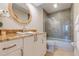 Bathroom with granite counters, oval mirror, tiled shower with glass enclosure, and vanity at 334 7Th N Ave, Tierra Verde, FL 33715