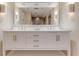 Bright bathroom features a double sink vanity, large mirror, modern fixtures, and recessed lighting at 334 7Th N Ave, Tierra Verde, FL 33715