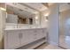 Bright bathroom features a double sink vanity, large mirror, modern fixtures, and recessed lighting at 334 7Th N Ave, Tierra Verde, FL 33715
