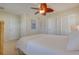 Bedroom featuring a white comforter, beige carpet, ceiling fan and multiple closets at 334 7Th N Ave, Tierra Verde, FL 33715