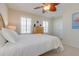 Well-lit bedroom with a decorative ceiling fan and shuttered windows at 334 7Th N Ave, Tierra Verde, FL 33715