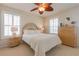 Comfortable bedroom with a decorative ceiling fan, side table lamps, and natural light at 334 7Th N Ave, Tierra Verde, FL 33715