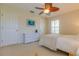 Relaxing bedroom with neutral colors features wicker dresser, comfortable bed and ceiling fan at 334 7Th N Ave, Tierra Verde, FL 33715