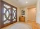 Inviting home entrance featuring decorative glass doors and a woven accent rug at 334 7Th N Ave, Tierra Verde, FL 33715