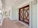 Inviting front entrance with detailed wood door, sidelights, and a spacious covered porch at 334 7Th N Ave, Tierra Verde, FL 33715