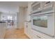 Bright kitchen view showcasing built-in oven and microwave with a partial view of the dining area at 334 7Th N Ave, Tierra Verde, FL 33715