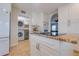 View of kitchen appliances with granite countertop and nearby washer and dryer laundry closet at 334 7Th N Ave, Tierra Verde, FL 33715