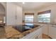 Open kitchen design featuring granite countertops and white cabinetry with an electric cooktop at 334 7Th N Ave, Tierra Verde, FL 33715