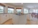 Bright kitchen featuring white cabinets, granite countertops, and an island with cooktop at 334 7Th N Ave, Tierra Verde, FL 33715