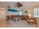Large living room boasts tile floors, high ceilings, bright windows and comfortable, oversized couch at 334 7Th N Ave, Tierra Verde, FL 33715