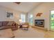 Relaxing living room features tile floors, bright windows, a fireplace, and comfortable couches at 334 7Th N Ave, Tierra Verde, FL 33715