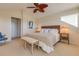 Spacious main bedroom features a ceiling fan, ensuite bath, large bed, and comfortable furnishings at 334 7Th N Ave, Tierra Verde, FL 33715