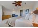 Spacious main bedroom features a ceiling fan, fireplace, large bed, and comfortable furnishings at 334 7Th N Ave, Tierra Verde, FL 33715