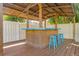 Relaxing tiki bar area with a stylish counter, bamboo accents, and poolside stools at 334 7Th N Ave, Tierra Verde, FL 33715