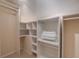 Walk-in closet with built-in shelving, hanging rods, and ample storage space at 334 7Th N Ave, Tierra Verde, FL 33715