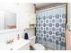 Bathroom with shower curtain and cabinet above the toilet at 7585 Kavanda St, North Port, FL 34287