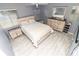 Bedroom featuring a bed, dresser, and end tables with white wood finish at 7585 Kavanda St, North Port, FL 34287