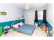 Cozy bedroom with unique blue accents, a comfortable bed, and a serene atmosphere, perfect for relaxation at 7585 Kavanda St, North Port, FL 34287