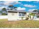 Charming home exterior featuring a well-maintained lawn and lovely landscaping at 7585 Kavanda St, North Port, FL 34287