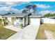 Lovely one-story home with a attached garage, gray roof, inviting entrance, and a neatly maintained lawn at 7585 Kavanda St, North Port, FL 34287