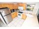 Bright kitchen with stainless steel appliances, ample cabinet space, and an easy-to-clean tile floor at 7585 Kavanda St, North Port, FL 34287
