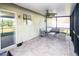 Relaxing screened-in patio area with brick pavers and comfortable wicker furniture at 7585 Kavanda St, North Port, FL 34287