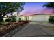 Charming single-story home with a two-car garage, white brick, and beautiful landscaping at 7405 Clearview Dr, Tampa, FL 33634