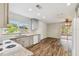 Spacious kitchen blending functionality and style, with hardwood floors and access to an outdoor area at 7405 Clearview Dr, Tampa, FL 33634