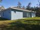 Backyard view of home featuring a manicured lawn and clean exterior, ideal for outdoor enjoyment at 16029 Arcaro Ave, Port Charlotte, FL 33954