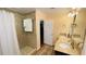 Bathroom featuring a tiled walk-in shower, and double sink vanity at 4250 Shamrock Dr, Venice, FL 34293